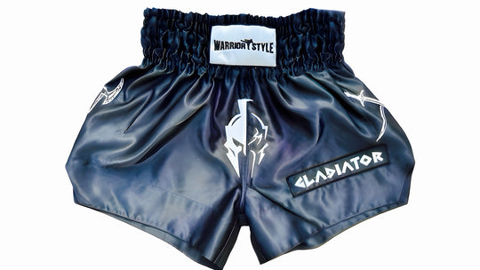 Blue boxing shorts with Warrior Style and Gladiator logos on a white background a product of https://www.shopwarriorstyle.com/
