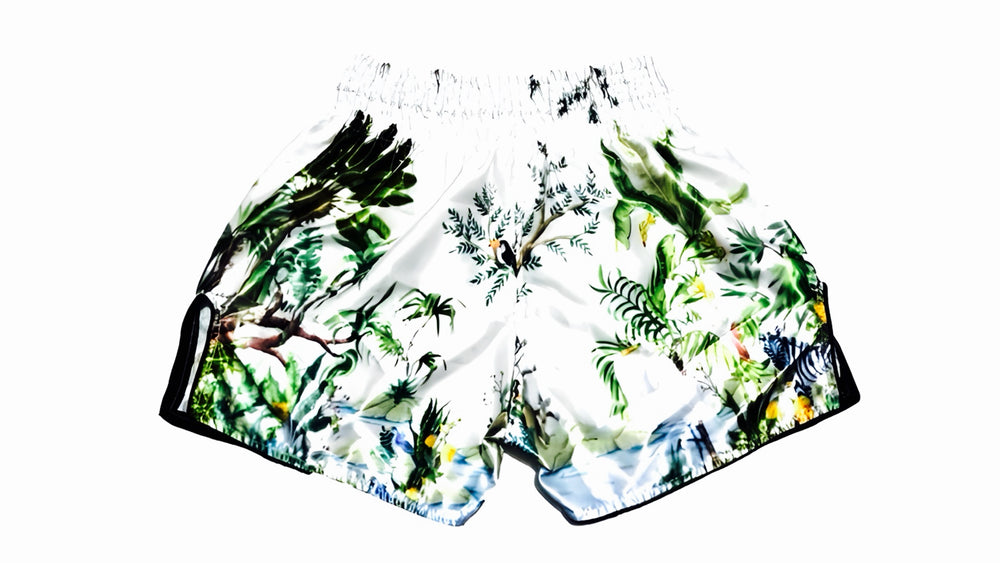 muay thai shorts Tropical-themed shorts with green leaves and birds on a white background muay thai shorts for men muay thai shorts twins a product of https://www.shopwarriorstyle.com/
background