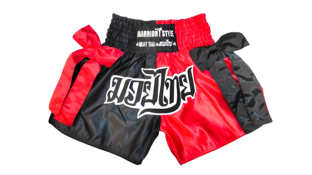 Black and red boxing shorts with visible branding on a white background  muay thai shorts for men muay thai shorts twins a product of https://www.shopwarriorstyle.com/
