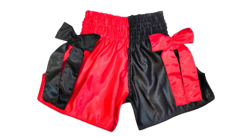 boxing shorts Black and red shorts with large bows on a white background Black and red boxing shorts with visible branding on a white background  muay thai shorts for men muay thai shorts twins a product of https://www.shopwarriorstyle.com/
