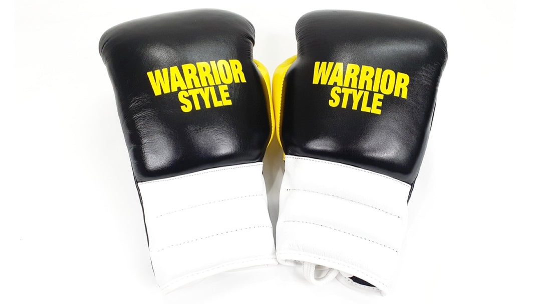A pair of black and red boxing pro fight gloves with 'WARRIOR STYLE' written on them a product of https://www.shopwarriorstyle.com/
