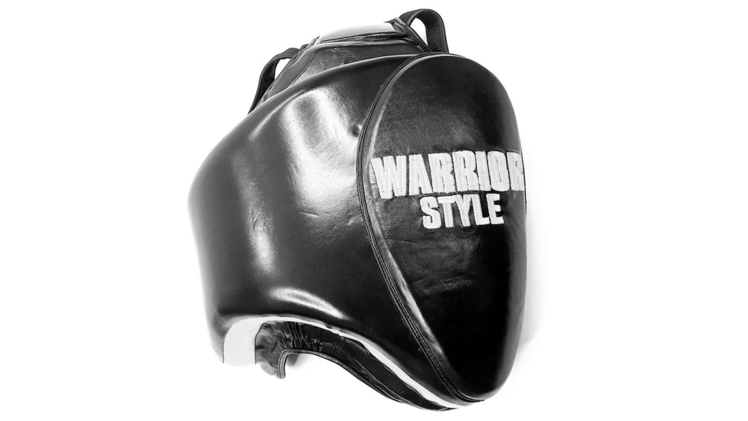 Thigh Pads muay thai elbow pads kick pads karate thai shin pads kick pads wrestling A pair of black leather thigh pads with white accents, featuring foam padding and a locking nylon waist strap a product of https://www.shopwarriorstyle.com/
