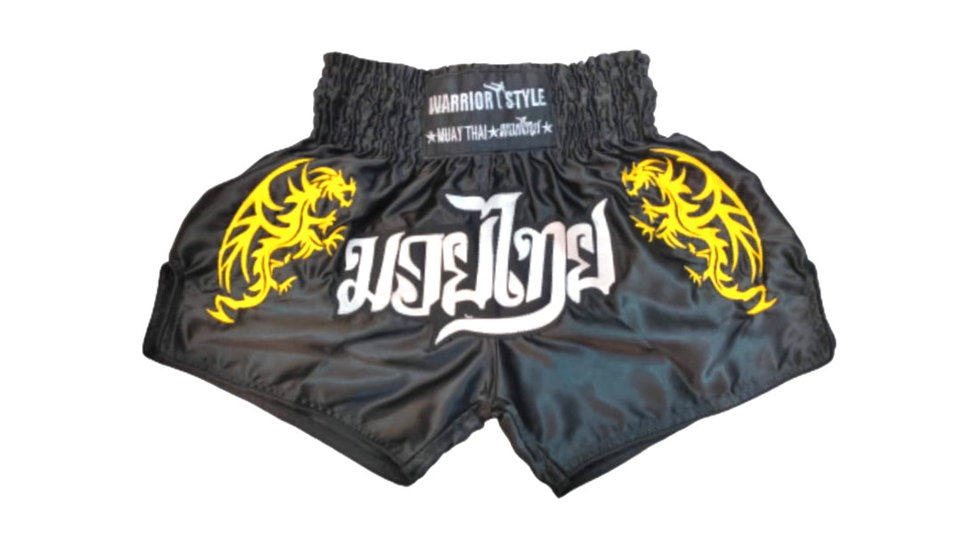 Muay Thai shorts A pair of black Muay Thai shorts with yellow and white decorative patterns and text on the front. muay thai shorts for men muay thai shorts twins venum muay thai shorts a product of https://www.shopwarriorstyle.com/
